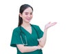 Professional young Asian woman doctor wears medical clothing while shows her hand to suggest something on white background. Royalty Free Stock Photo