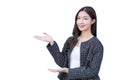 Professional young Asian working woman who wears black suit with braces on teeth is pointing hand to present something confident Royalty Free Stock Photo