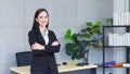 Professional young business Asian working woman who has long hair wears black formal suit with blue shirt while she arm crossing Royalty Free Stock Photo