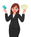 Professional young business woman showing/holding credit/debit/ATM banking card and cash/money/currency bank notes in hand. Modern