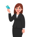 Professional young business woman showing or holding credit/debit/ATM card. Female executive displaying banking card. Modern. Royalty Free Stock Photo