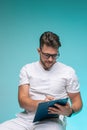 Professional young male physician practitioner in glasses, medical uniform writing doctor report. Job in hospital Royalty Free Stock Photo