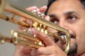 Young man playing trumpet in studio Royalty Free Stock Photo