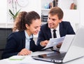 professional young man and woman coworkers talking in firm office Royalty Free Stock Photo