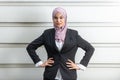 Professional Young Muslim Asian businesswoman hands on waist. Angry expression. White background