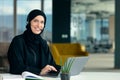 Professional young muslim business woman using mobile digital tablet computer at work Royalty Free Stock Photo