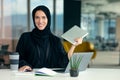 Professional young muslim business woman using mobile digital tablet computer at work Royalty Free Stock Photo