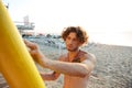 Professional young surfer getting board ready for surf Royalty Free Stock Photo