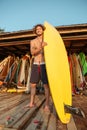Professional young surfer getting board ready for surf Royalty Free Stock Photo