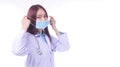 Woman doctor in uniform white clothes with stethoscope while wearing medical mask protection from inhaling Royalty Free Stock Photo