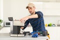 professional young worker fixing coffee machine Royalty Free Stock Photo