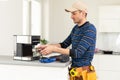 professional young worker fixing coffee machine Royalty Free Stock Photo