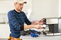 professional young worker fixing coffee machine Royalty Free Stock Photo
