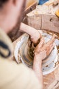 Man Working with Clay on Potter`s Wheel Inside of Workshop Royalty Free Stock Photo