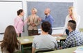 Professor consulting different age students Royalty Free Stock Photo