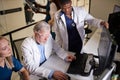 Professor Doctors discussing studying Mammogram film x-ray of patient 's head for brain, skull injury on computer