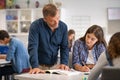 Professor helping college student during lesson Royalty Free Stock Photo