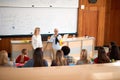 Professor helping student in class in university engaged in education Royalty Free Stock Photo