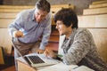 Professor helping a student in classroom