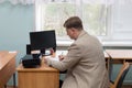 A professor at the institute at his desk by the window Royalty Free Stock Photo