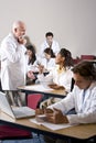 Professor with medical students in classroom Royalty Free Stock Photo