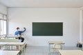 Professor sitting in an empty classroom