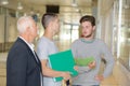 Professor talking to students in corridor Royalty Free Stock Photo
