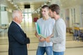 professor talking to students in school corridor Royalty Free Stock Photo