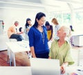 Professor Teaching a Senior Adult in the Office