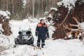 Proffesional Lumberjack hold hand saw. Winter wearing protection clothes using chainsaw. clean fallen trees Royalty Free Stock Photo