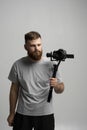 Proffesional videographer making a good footage using steadicam. Cameraman creator with a stabilizer in his hands takes Royalty Free Stock Photo