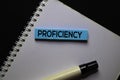 Proficiency text on sticky notes. Office desk background