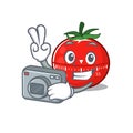 A proficient photographer tomato kitchen timer cartoon design concept working with camera