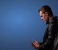 Profil shot from a young man in leatherjacket, rubbing his hand with copyspace Royalty Free Stock Photo