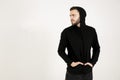 In profile an attractive young man with a small beard in black c Royalty Free Stock Photo