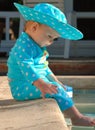 Profile of baby with feet in swimming pool