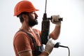 Profile of bearded builder in helmet. Man works with drill. Repairer man in protective hard hat. Builder isolated on white