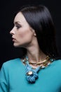 Profile of beautiful fashionable woman wearing cyan clothes and jewellery