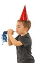 Profile of boy blowing noise maker Royalty Free Stock Photo