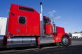 Profile of bright red American big rig semi truck with chrome ac Royalty Free Stock Photo