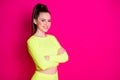 Profile of charming nice young woman stand smiling crossed hands dress sport suit look empty space isolated on vibrant