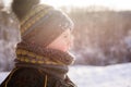 Portrait of small boy in winter sunset outdoors