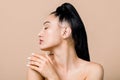 Profile close up beauty portrait of gorgeous pleasant naked young asian woman with flawless skin, touching her shoulder Royalty Free Stock Photo