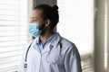 Profile pensive African American man doctor in medical mask thinking Royalty Free Stock Photo