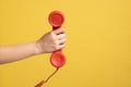 Profile closeup of woman hand holding and showing red call telephone handset receiver, call center. Royalty Free Stock Photo