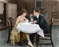 Profile of a couple sitting at a table Royalty Free Stock Photo