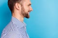 Profile cropped close up portrait of satisfied glad man toothy smile look empty space isolated on blue color background