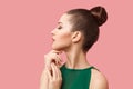 Profile side view portrait of calm serious beautiful young woman with bun hairstyle and makeup in green dress standing with closed Royalty Free Stock Photo