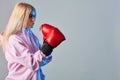 Sporty sexy woman wearing pink hoodie and red boxing gloves on white background Royalty Free Stock Photo