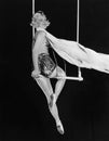 Profile of a female circus performer performing on a trapeze bar Royalty Free Stock Photo